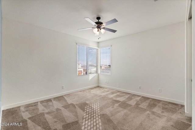 carpeted empty room featuring ceiling fan