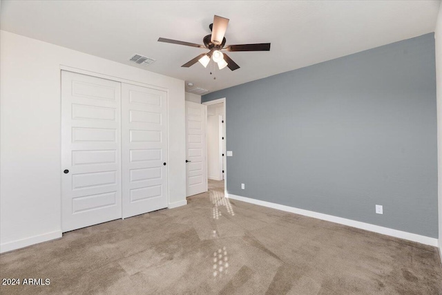 unfurnished bedroom with ceiling fan, a closet, and carpet