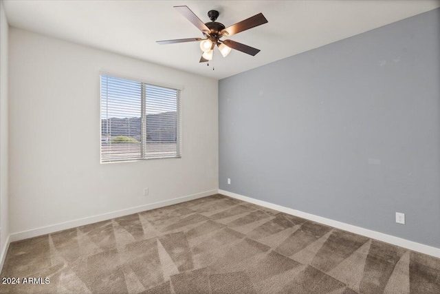 unfurnished room featuring light carpet and ceiling fan