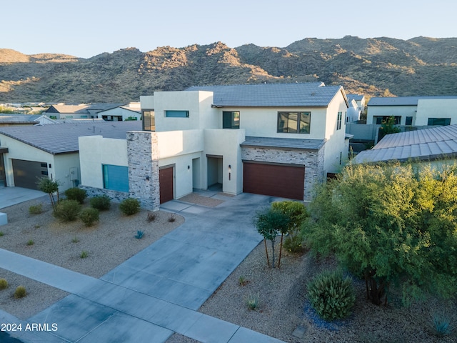 contemporary house with a mountain view and a garage