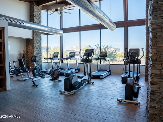 workout area with a high ceiling and ceiling fan