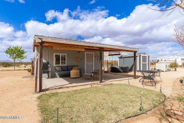 back of house with a patio area, a shed, metal roof, and an outdoor structure