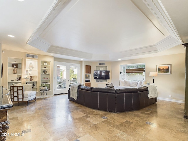 living room with french doors, built in features, crown molding, and a tray ceiling