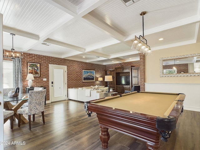 rec room featuring dark hardwood / wood-style flooring, beam ceiling, a healthy amount of sunlight, and brick wall