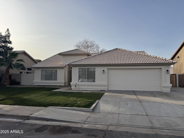 view of front of house with a yard and a garage