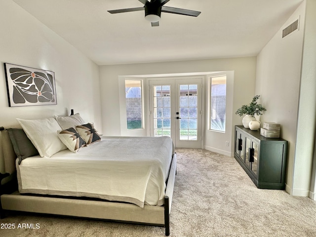 bedroom featuring light carpet, access to outside, ceiling fan, and french doors