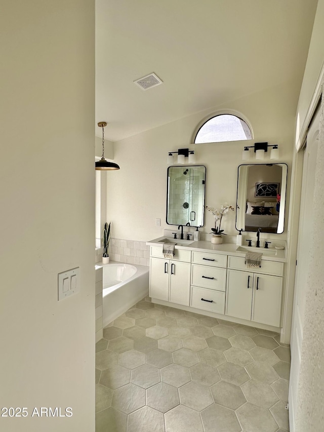 bathroom with vanity and separate shower and tub