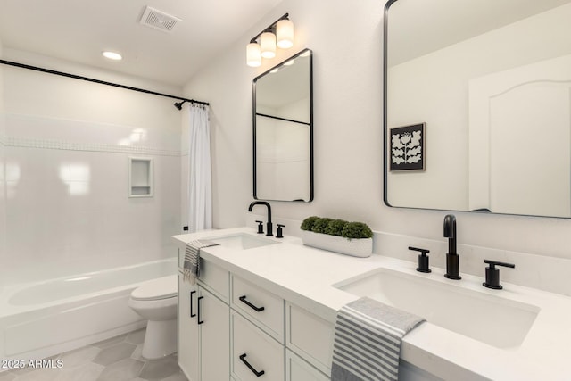 full bathroom with shower / bathtub combination with curtain, vanity, tile patterned floors, and toilet