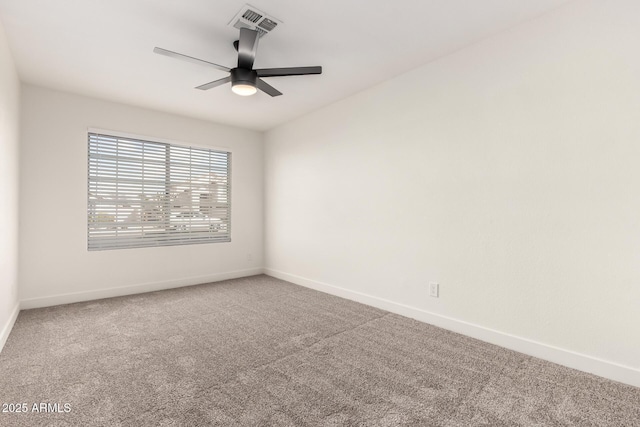 carpeted spare room featuring ceiling fan