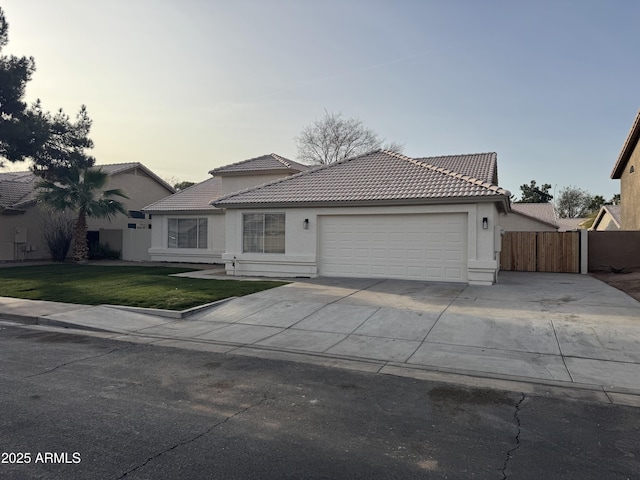 view of front of house with a garage and a lawn