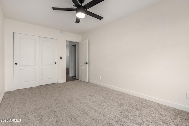 unfurnished bedroom featuring ceiling fan, a closet, and carpet