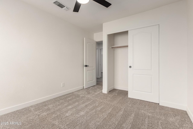 unfurnished bedroom featuring light carpet, a closet, and ceiling fan