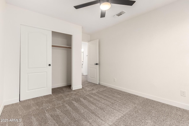 unfurnished bedroom featuring carpet floors, a closet, and ceiling fan