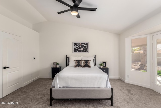 carpeted bedroom with vaulted ceiling and ceiling fan