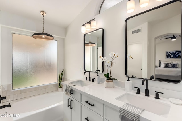 bathroom featuring vanity and a bathtub