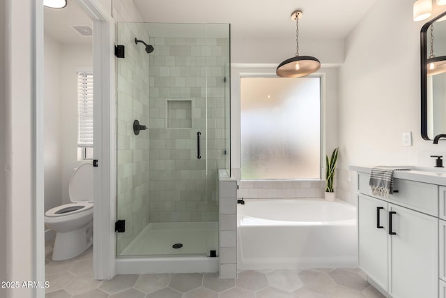 full bathroom featuring vanity, toilet, independent shower and bath, and tile patterned flooring