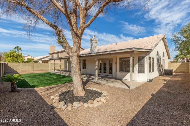 back of house with french doors, central AC unit, and a patio