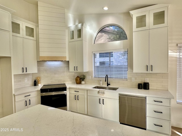 kitchen with white cabinetry, stainless steel electric stove, dishwasher, and sink