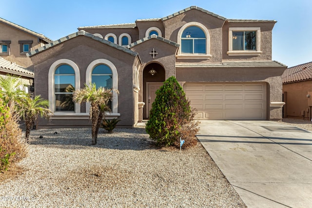 9207 W Kirby Ave, Tolleson, AZ 85353 - mediterranean / spanish-style house with driveway, an attached garage, stucco siding, and a tiled roof