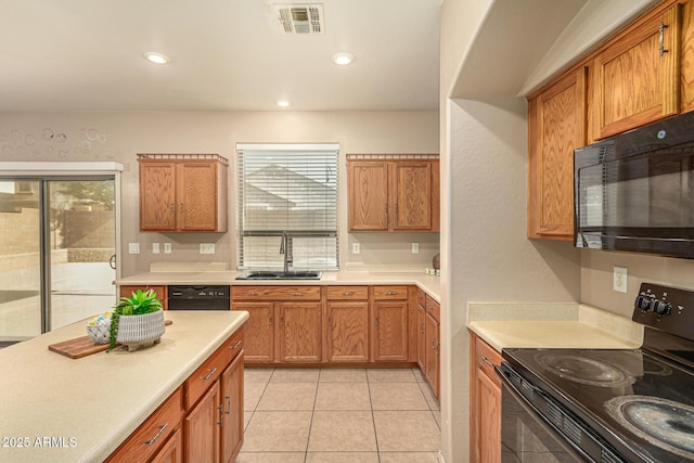 9207 W Kirby Ave, Tolleson, AZ 85353 - kitchen with black appliances, a sink, light countertops, brown cabinets, and recessed lighting
