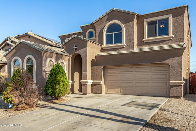 9207 W Kirby Ave, Tolleson, AZ 85353 - view of front of house with a garage, stucco siding, driveway, solar panels, and a tile roof