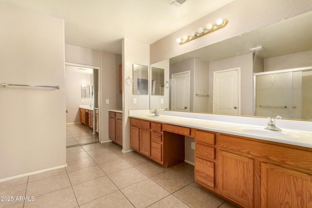 9207 W Kirby Ave, Tolleson, AZ 85353 - bathroom with double vanity, a stall shower, tile patterned floors, and baseboards