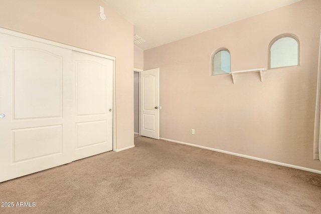 9207 W Kirby Ave, Tolleson, AZ 85353 - unfurnished bedroom with carpet floors, a closet, and baseboards