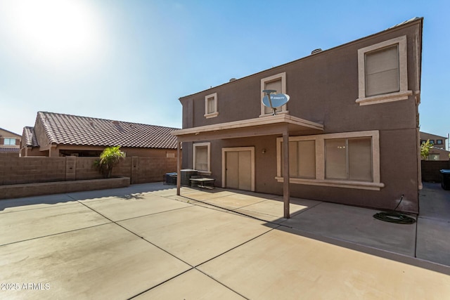 9207 W Kirby Ave, Tolleson, AZ 85353 - rear view of house with a fenced backyard, a patio, and stucco siding