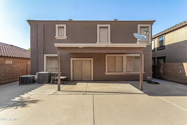 9207 W Kirby Ave, Tolleson, AZ 85353 - view of front of home with central AC unit, a patio area, and stucco siding