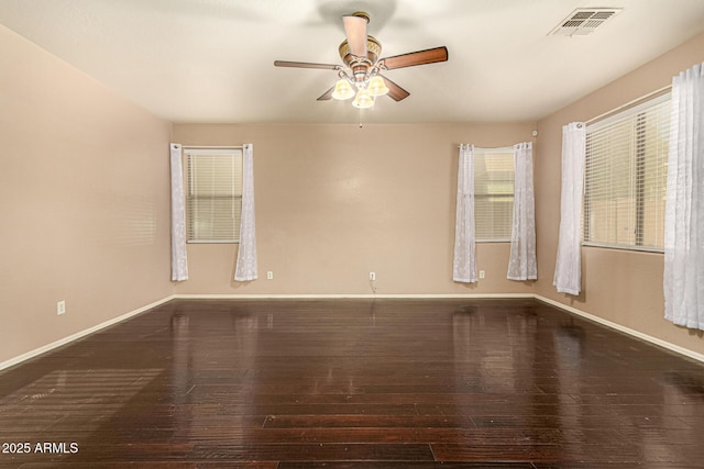 9207 W Kirby Ave, Tolleson, AZ 85353 - unfurnished room with wood-type flooring, ceiling fan, and baseboards