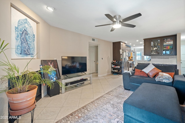 tiled living room featuring ceiling fan