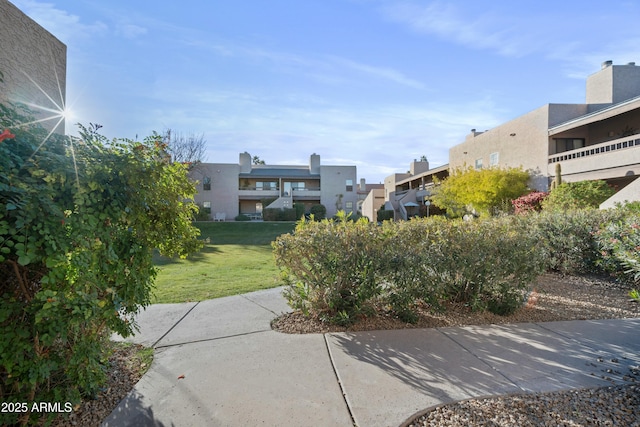 view of home's community featuring a lawn