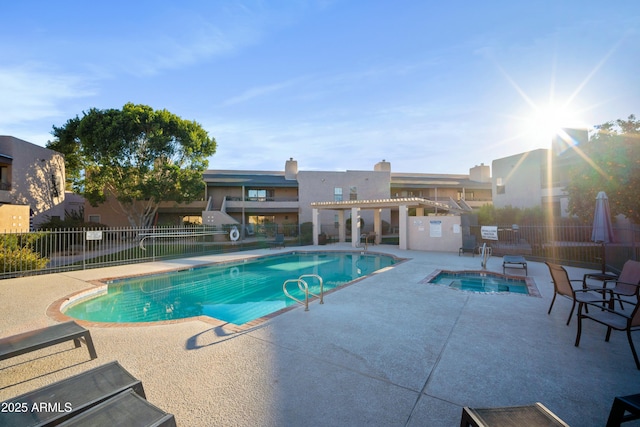 view of swimming pool with a hot tub, a patio, and a pergola