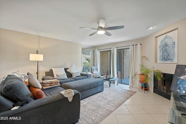 tiled living room featuring ceiling fan