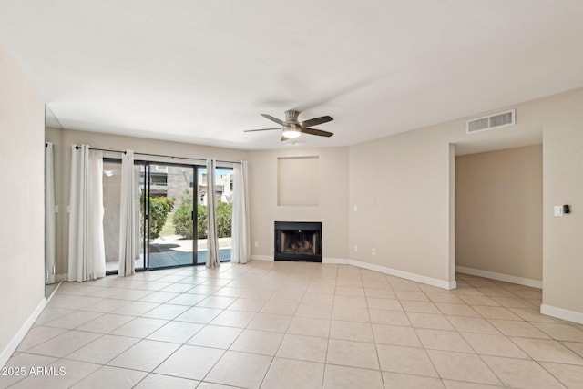 5998 N 78th St Unit 116, Scottsdale, AZ 85250 - unfurnished living room featuring a ceiling fan, baseboards, a fireplace, and visible vents