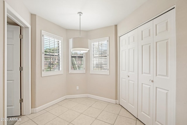 5998 N 78th St Unit 116, Scottsdale, AZ 85250 - unfurnished dining area featuring baseboards and light tile patterned floors