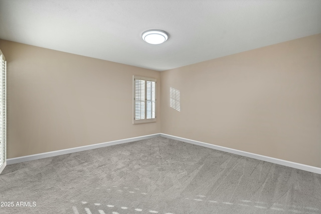 unfurnished room featuring light carpet