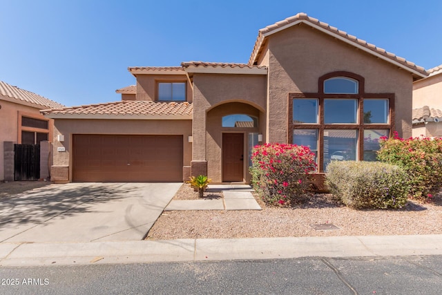 8928 E Crescent Ave, Mesa, AZ 85208 - mediterranean / spanish-style house with an attached garage, stucco siding, a tiled roof, and driveway