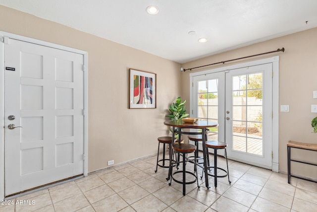 dining area featuring french doors and light tile patterned flooring