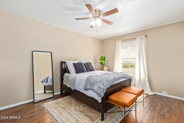 bedroom featuring ceiling fan and dark hardwood / wood-style floors