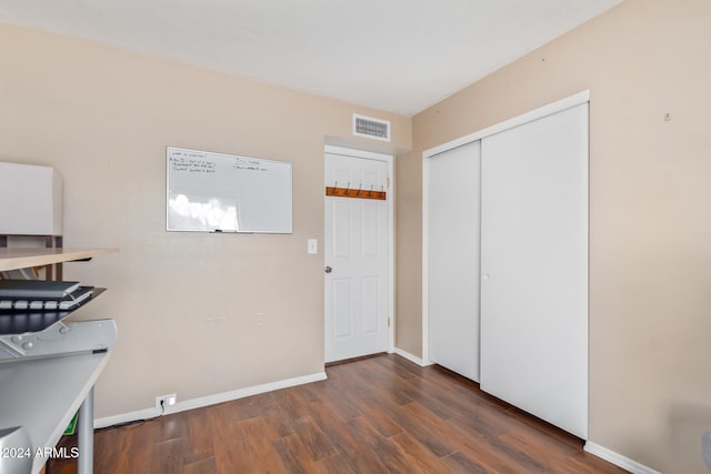 unfurnished office with dark hardwood / wood-style flooring