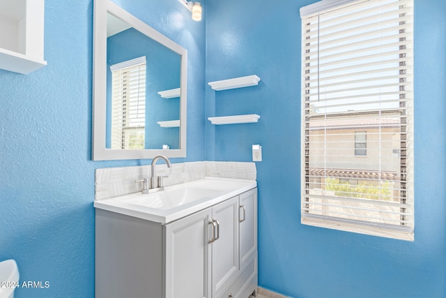 bathroom featuring a wealth of natural light and vanity