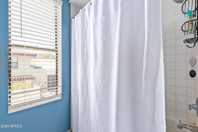 bathroom with shower / bathtub combination with curtain