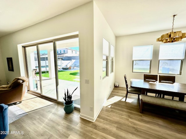 entryway featuring wood-type flooring and a chandelier