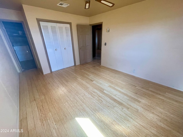 unfurnished bedroom featuring a closet and light wood-type flooring