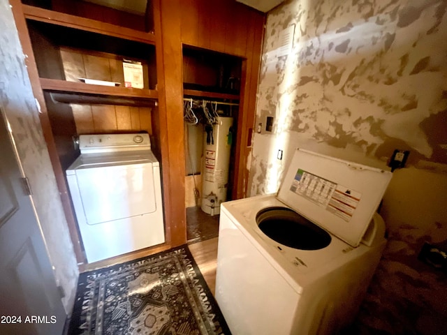 laundry room with water heater and washer / dryer