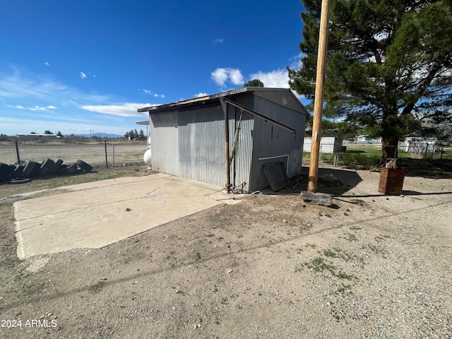 view of side of home featuring an outdoor structure