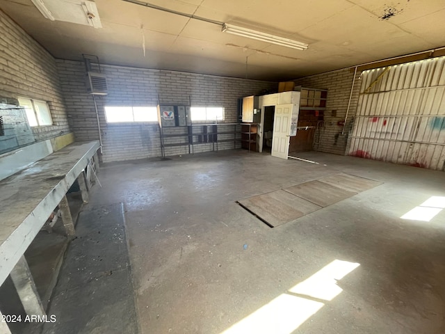 interior space featuring brick wall and a healthy amount of sunlight