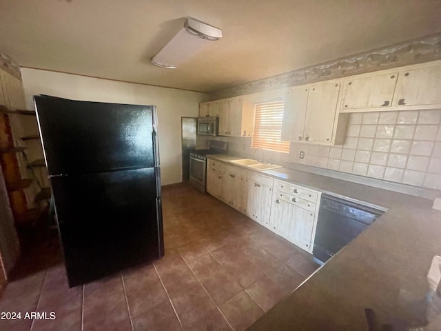 kitchen with range, backsplash, dark tile floors, dishwasher, and black fridge