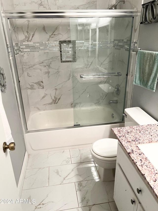 full bathroom with shower / bath combination with glass door, vanity, and toilet